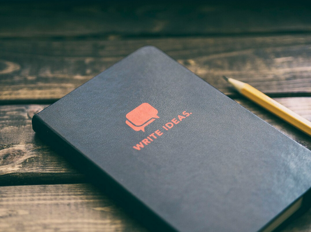 Notebook with survey questions and a pen